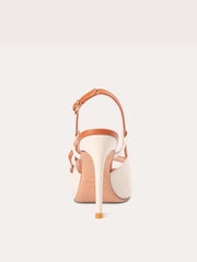 A pair of stylish sandals with a pearl bow detail.