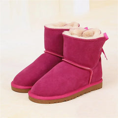 Pink suede ankle snow boots with bow detail