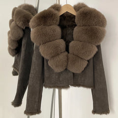 Fur-collar suede jacket displayed in studio lighting, showcasing structured sleeves and refined outerwear finish