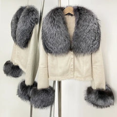 Studio image of a cropped suede jacket with fur trim, presented under neutral lighting to show shape and finish