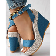 Close-up of blue ankle strap denim wedges
