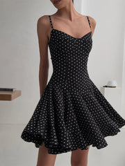 close view of fitted bodice on black polka dot a-line dress