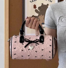 Sweet pink Boston bag with black bow accents