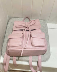 Vintage-inspired pink mochila with flap pockets