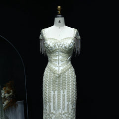 Elegant beaded gown on a mannequin against a black background