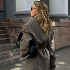 Tailored black jacket layered over knit for autumn city style