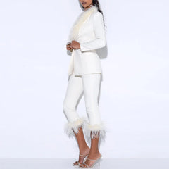 Close view highlighting feather detailing along the blazer lapel and sharp tailored neckline