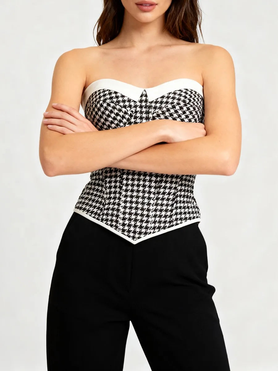Close-up of a structured gingham corset top with clean neckline and fitted waist detail.