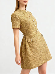 Close-up of bodice showing decorative button placement, structured waist shaping, and woven texture.