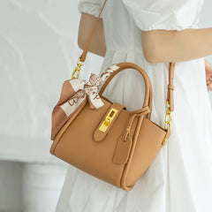 Tan genuine cow leather tote bag with structured silhouette and gold-tone hardware