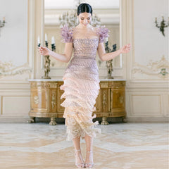 The tassel-embellished wedding party gown is styled for a glamorous event.