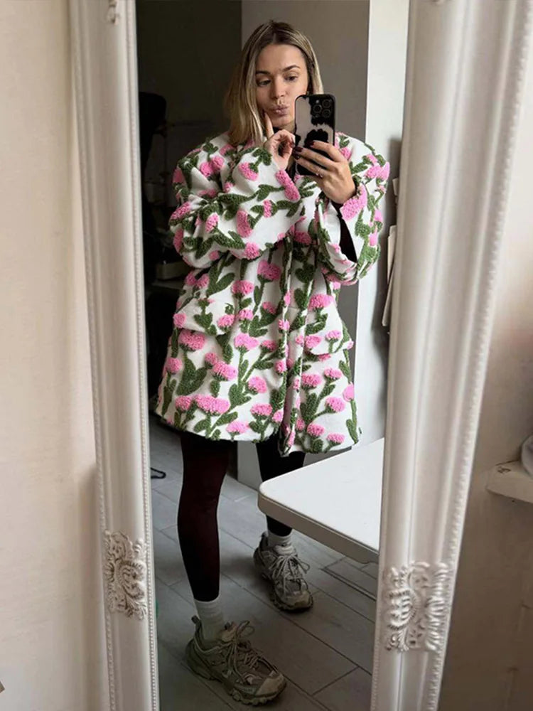 Front view of a floral textured fleece jacket with lapel collar and single-breasted closure, styled as a statement outer layer.