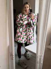 Front view of a floral textured fleece jacket with lapel collar and single-breasted closure, styled as a statement outer layer.
