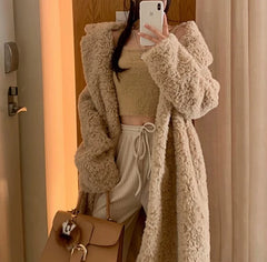 Woman wearing thick faux fur long coat with belt