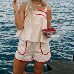 A front view of the tie-shoulder peplum top, showing the babydoll silhouette.