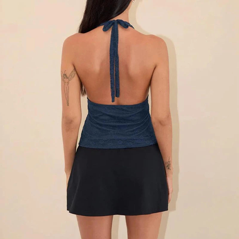 A tie-up halterneck camisole styled with high-waisted shorts for a casual look.