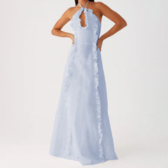 A full-length shot of the tiered backless gown styled for a formal event.
