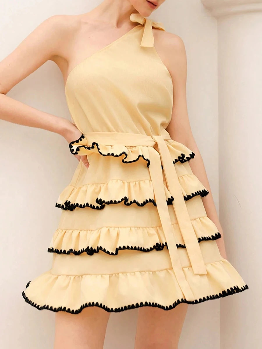 Tiered ruffle dress styled for summer events and rooftop parties on a plain background