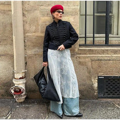 Detail shot focusing on the jacket’s tonal braid texture and seams, with sunlight emphasizing the structured weave and front panel design.