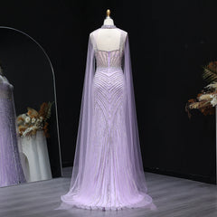 Elegant tulle sweep train formal gala dress shown for upscale party wear with a cape on a mannequin against a dark background