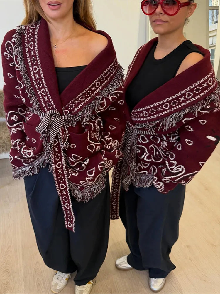 Front styling shot highlighting the turn-down collar and relaxed drape of the burgundy cardigan, worn like a light coat layer.
