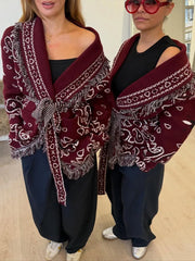 Front styling shot highlighting the turn-down collar and relaxed drape of the burgundy cardigan, worn like a light coat layer.