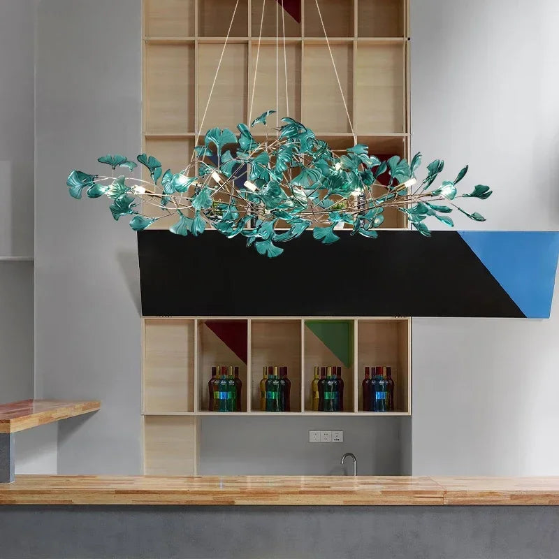 Turquoise leaf crystal chandelier styled above a modern bar