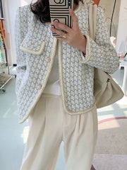 A woman wearing a high-quality French vintage tweed jacket in a plaid pattern.

