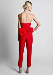 Red evening jumpsuit with bow detail and detachable skirt