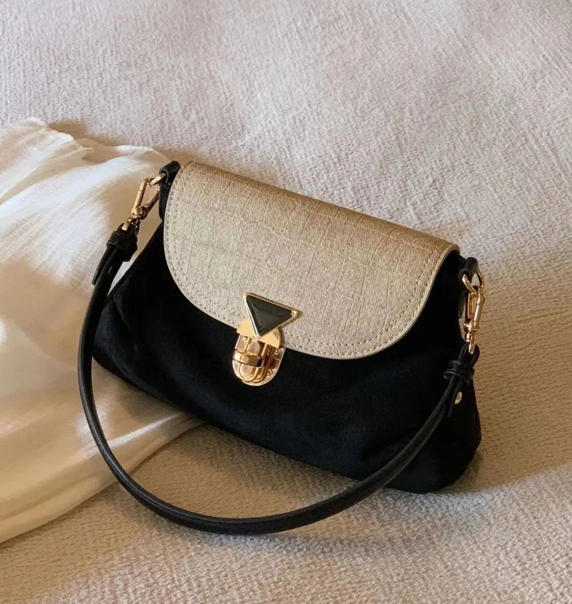 Two-tone black and beige vintage crossbody bag with gold clasp