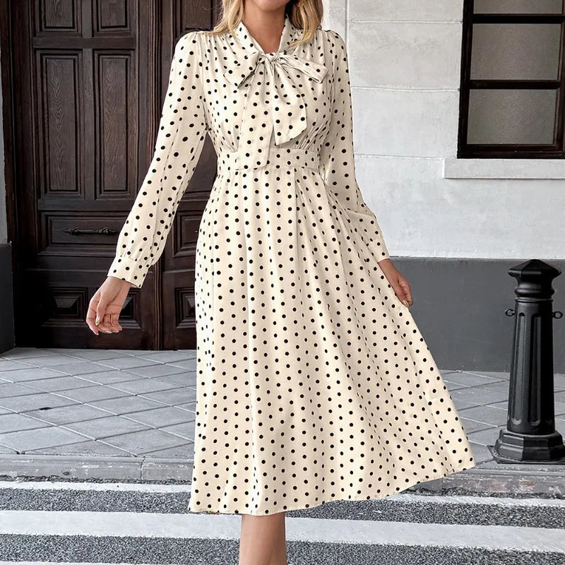 Close view of bow-tie neckline on a polka dot dress