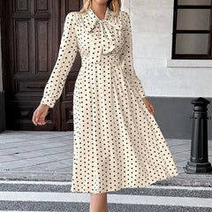 Close view of bow-tie neckline on a polka dot dress