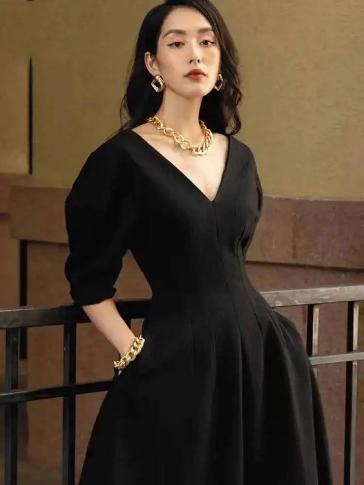 Close-up highlighting the V-neckline and softly puffed sleeves, showing crisp fabric structure and clean seam finishing.