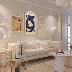 Modern living room with a beige sofa, decorative pillows, and abstract art on the wall.