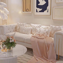 “Modern velvet lounge sofa with tufted back and cozy blanket in living room”
