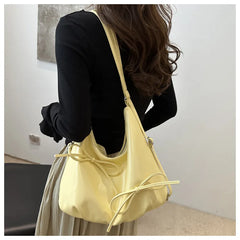 Casual yellow bow handbag in natural light

