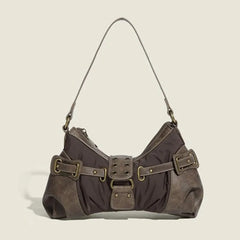 Brown Y2K-style shoulder bag with decorative buckles on beige background