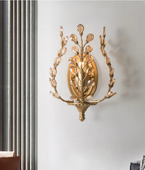 Vintage gold wall sconce adding romance to a modern bedroom