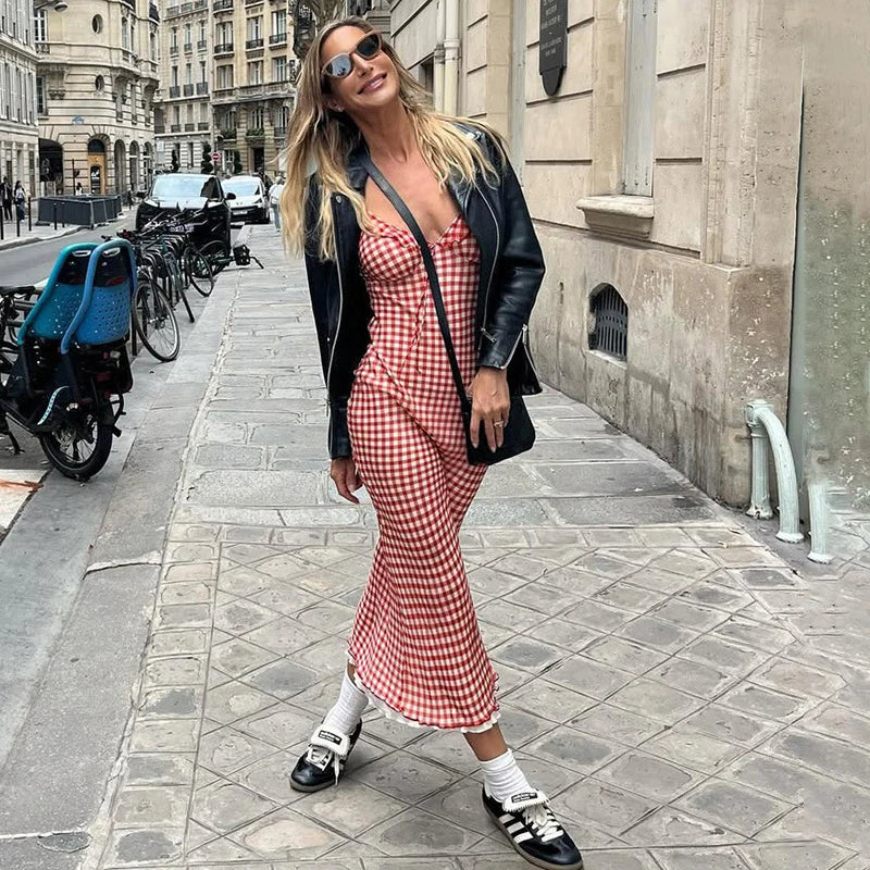 Woman in a Vintage-inspired red plaid dress with lace-up back and ankle length walking on a city street.
