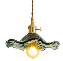 A pendant LED lights with  green colourful glass shades, as flowers with polished copper finishes, and hanging from the ceiling.
