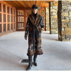 Outdoor look featuring a brown tassel-trim cardigan coat paired with a cowboy hat and boots, creating a bold western-inspired silhouette