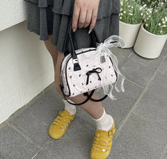 Small lace pillow purse with black handles