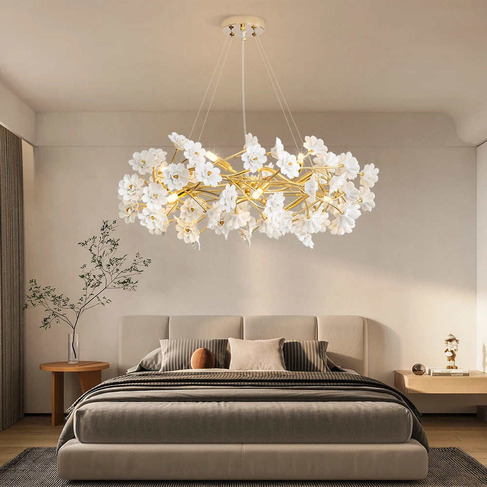 White blossom chandelier with ceramic flowers in a romantic bedroom setting