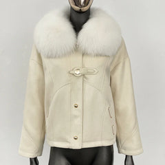 Close-up of the white fox fur collar on a beige winter coat.