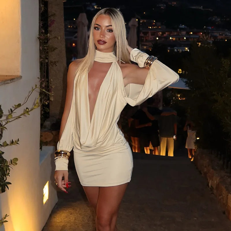 White halter backless mini dress with draped cutout styled for party nights