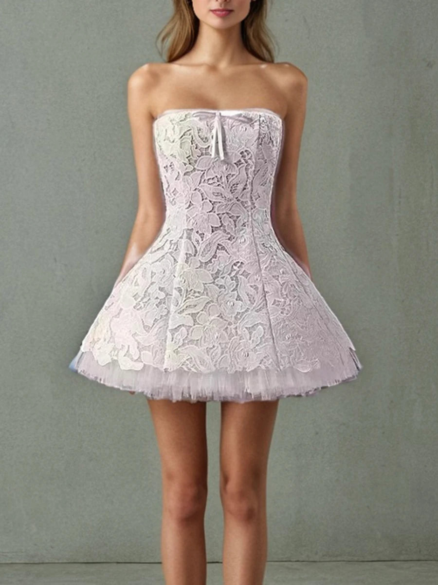 “White strapless mini dress with lace and mesh overlay”

