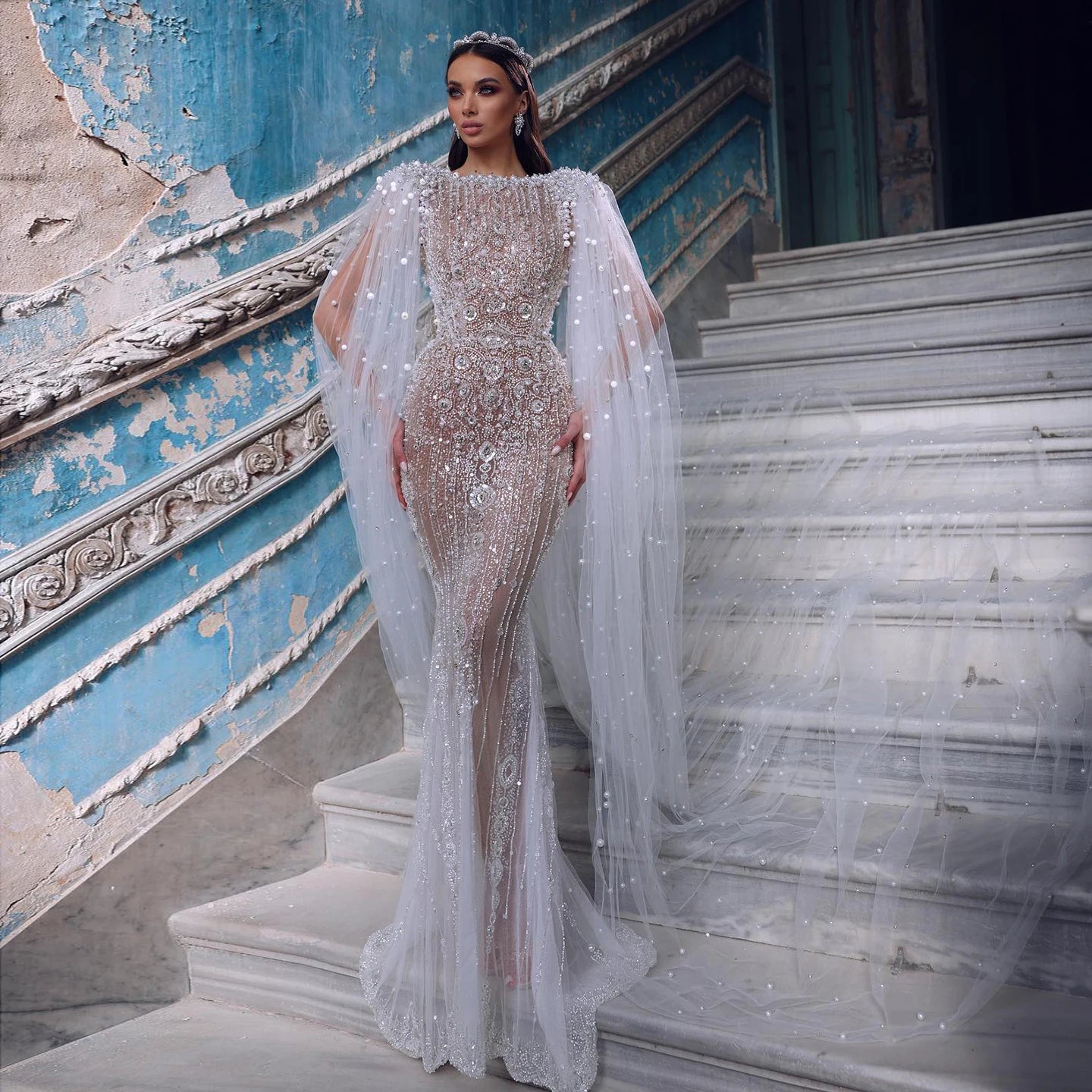 White mermaid evening gown with cape sleeves and sweep train