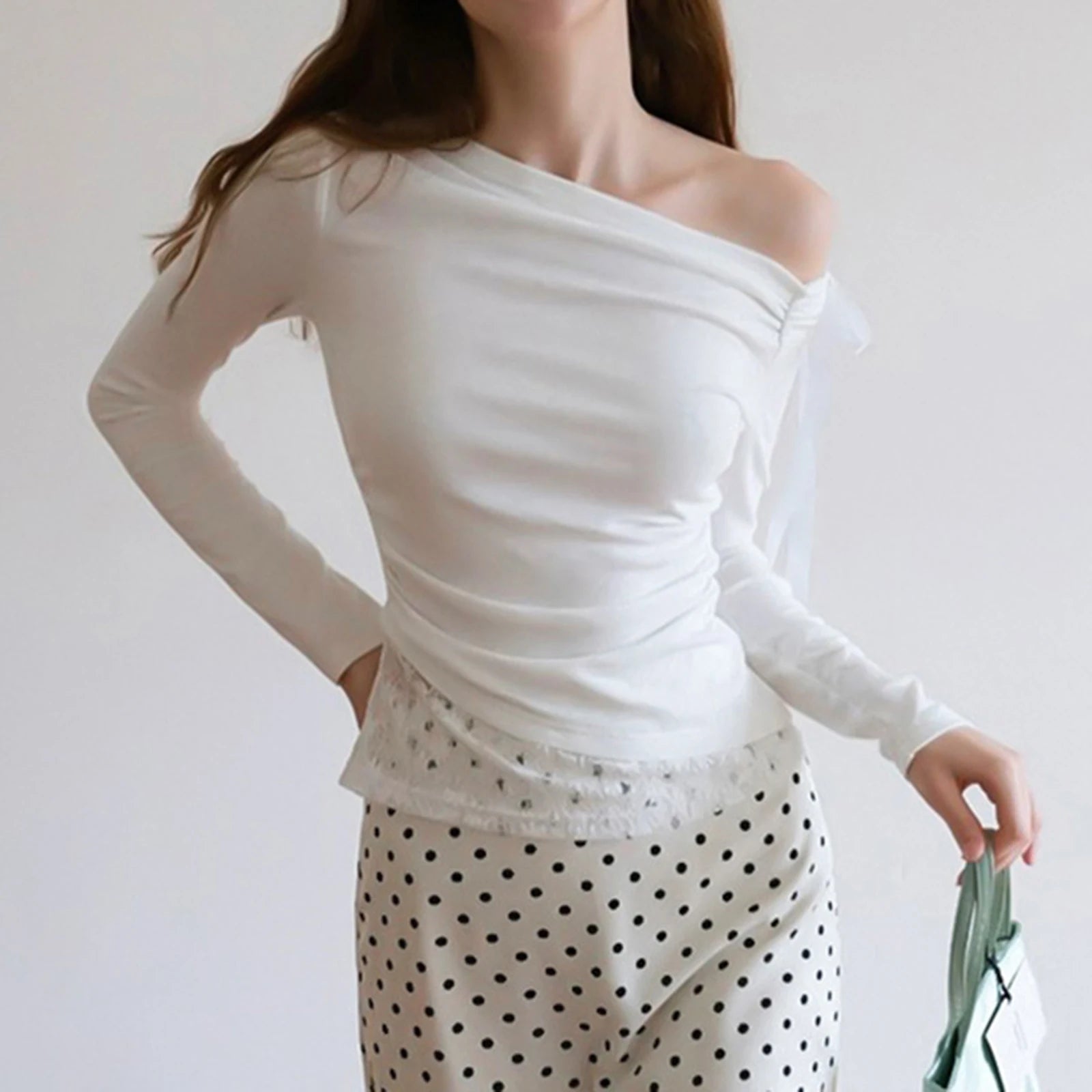 White off-shoulder lace top styled with polka dot skirt