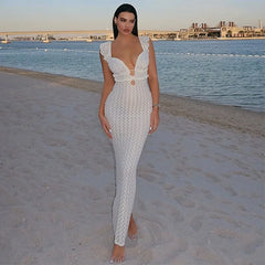 This image features a sleeveless, long ankle-length dress designed with a flattering V-neck and an open back, highlighted by ruffled straps. The dress is crafted from a blend of polyester and spandex, offering a high stretch, form-fitting silhouette that combines style and comfort.