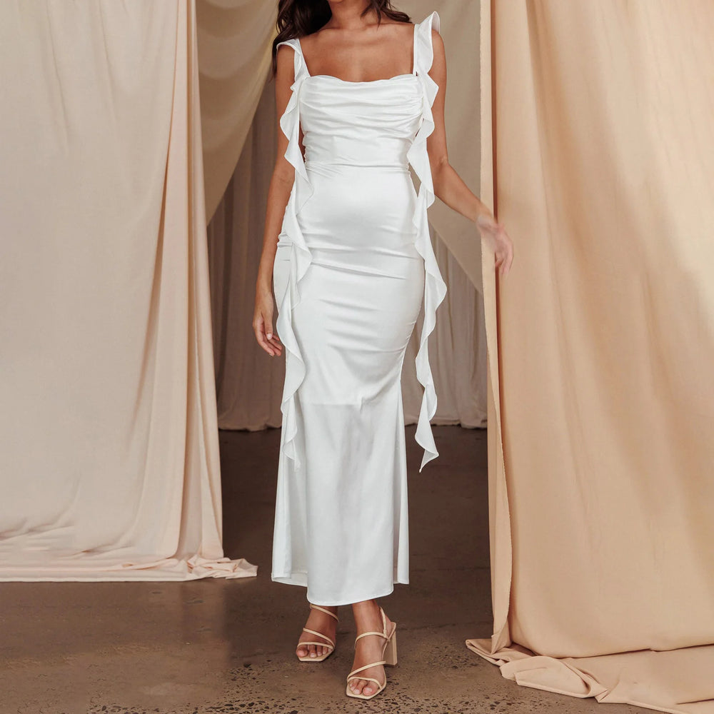 Elegant white ankle-length spaghetti strap dress styled against a white background